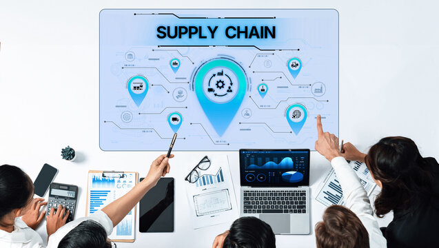 Business professionals engage in a discussion about innovative supply chain solutions, utilizing digital tools and data analysis in a modern office setting. Trope