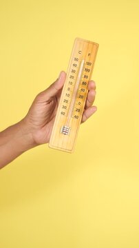 Measuring temperature with a thermometer in bright setting