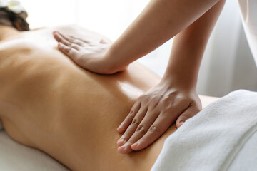 Closeup woman customer enjoying relaxing anti-stress spa massage and pampering with beauty skin...