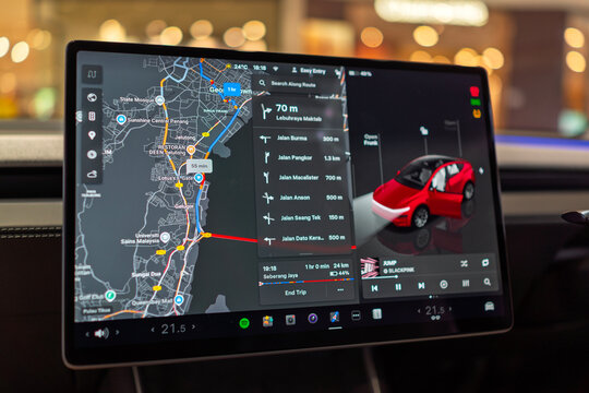 Penang, Malaysia &ndash; Oct 29, 2025: Close-up of a Tesla car&rsquo;s central touchscreen displaying a detailed GPS navigation map and digital control interface.