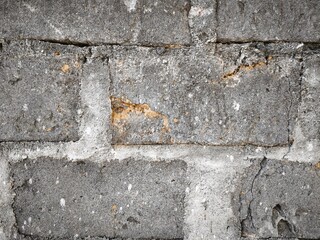 Close up of an old gray brick wall. Suitable for backgrounds, textures, construction themes, urban concepts, and vintage design elements.
