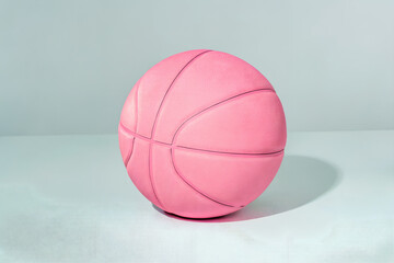 Modern pink basketball on clean studio background with soft lighting and realistic texture. Stylish minimal design for sport, fitness, or fashion themes. Perfect for creative commercial visuals.