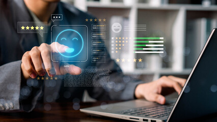 A person using a laptop to rate customer satisfaction with five-star feedback, showing online service quality, user experience, digital communication, and business review for marketing and improvement