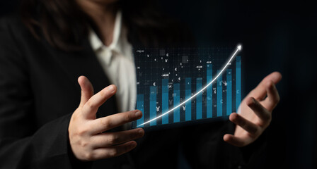 A businessman showcases a dynamic digital graph demonstrating an upward trend, representing data analytics and business growth. A focused environment conveys professionalism. Impute