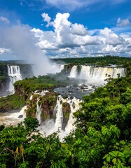 Scenic landscape featuring tiered waterfalls, lush greenery, and blue sky