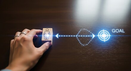 Hand guides wooden block figure towards glowing goal on dark wood surface, symbolizing achievement and aspiration in a conceptual image.