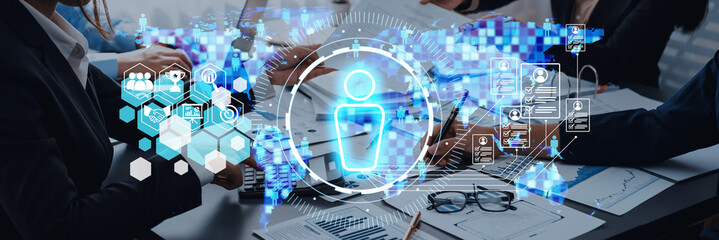 Business team in a modern office setting with digital interface and global data display showcasing information technology concepts and collaboration environment Trope.