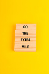 Wooden tiles spelling Go the Extra Mile to convey dedication and a growth mindset, motivating consistent effort and excellence at work.
