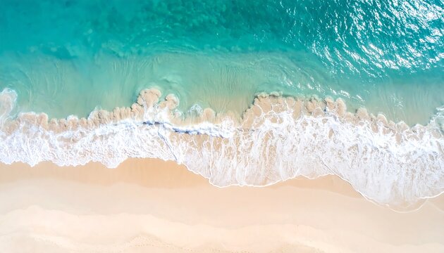 Aerial view of a pristine beach with turquoise waves breaking on the shore