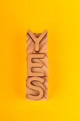 YES stacked vertically on blocks to represent solid commitment, alignment, and a firm go ahead.
