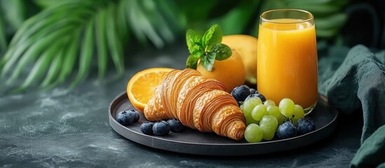 Tropical Breakfast Platter with Croissant, Orange Juice, and Fruits