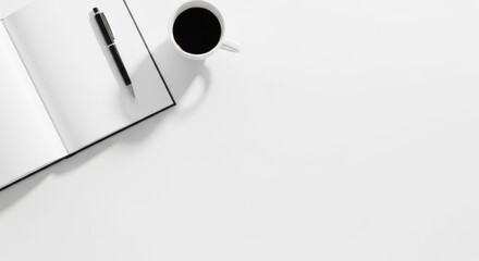 A minimalistic workspace with a laptop and a coffee cup on a white table, free space for text