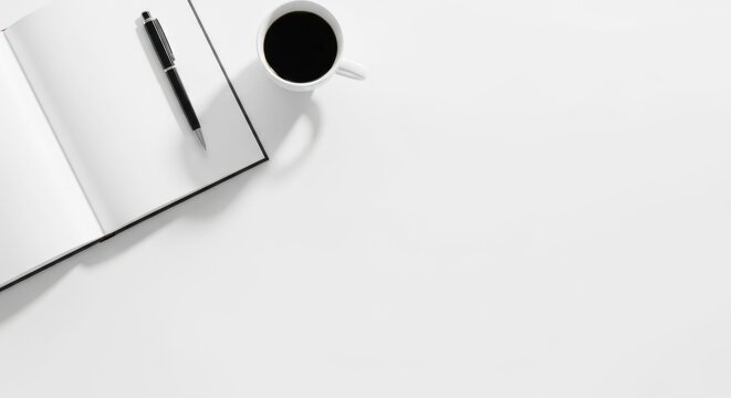 A minimalistic workspace with a laptop and a coffee cup on a white table, free space for text
