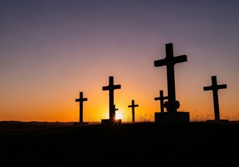 Silhouettes of crosses against a vibrant sunset sky with dramatic lighting