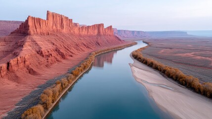 Vivid Red Rock Formations Along a Serene Blue River During Golden Hour With Autumn Trees Lining the Banks