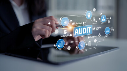 A business professional engages with advanced digital tools to streamline the audit process, focusing on compliance and materiality within a modern office environment. Tessel