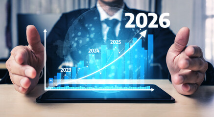 A businessman showcases financial growth projections using a digital graph on a tablet, illustrating strategic planning and future goals for 2026. Tessel