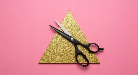 Black scissors resting on a golden triangle against a vibrant pink background, creating a minimalist composition.