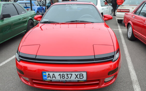 Vibrant red 1990 Toyota Celica GT-Four celebrated Japanese sports coupe recognizable by its rounded body and pop-up headlights