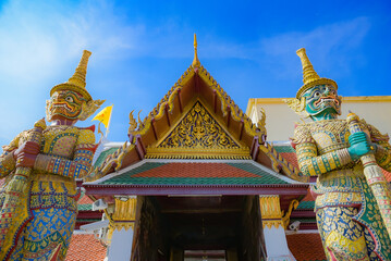 Two giant guardian statues at the Temple of the Emerald Buddha, magnificent and awe-inspiring symbols of protection that captivate visitors exploring Thailand’s rich cultural heritage.