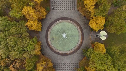 Aerial View of Circular Fountain Surrounded by Autumn Foliage in Warsaw Park