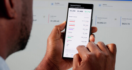 Young African American Accountant Using Smart Budget App