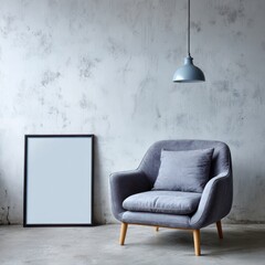 Gray armchair with picture frame and hanging lamp against textured wall.