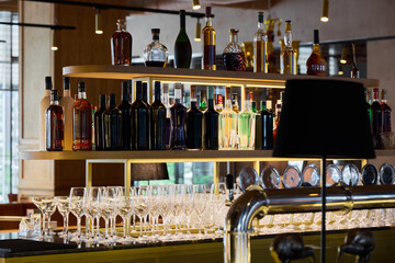 Stylish bar interior featuring a variety of bottles and glassware