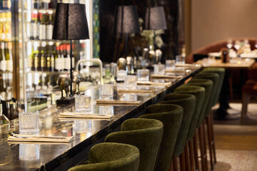 Elegant bar seating area in a modern restaurant with soft lighting