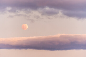 Harvest Moon Set in Pastel Clouds