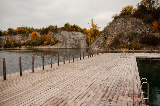 Autumn Lake with Wooden Pier and Cliffs