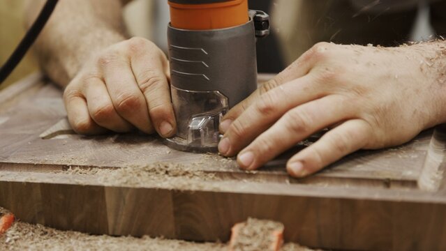 Precision woodworking with handheld router on secured timber
