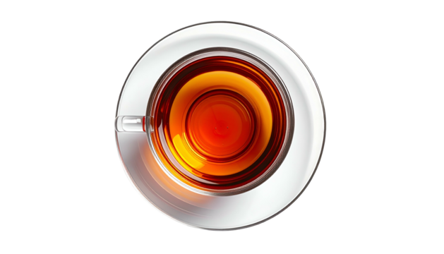 Overhead shot of warm, dark tea in a clear glass cup and saucer