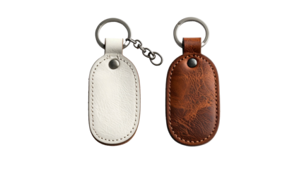 Two oval keychains, one white leather, one brown, on black background