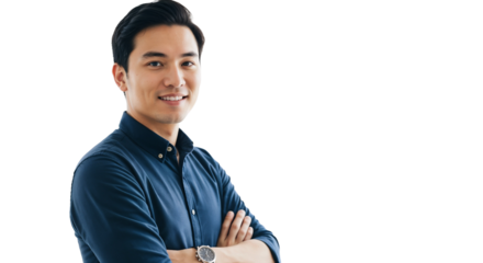 Smiling young man stands confidently with arms crossed in a casual blue shirt against a bright background