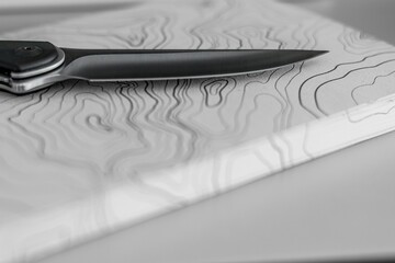 High resolution close up color image of a single traditional EDC pocket knife with a topographical map in the background- Israel