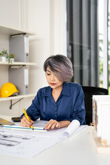 Architect or civil engineer working on blueprint structure floor plan by pen and triangular scale drawing design . Building planning design and construction concept.