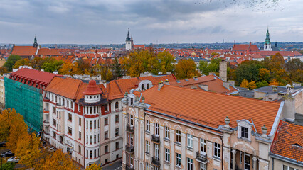 Autumn aerial view of Kalisz city center with town hall tower and church towers, historic buildings and red rooftops in traditional urban landscape