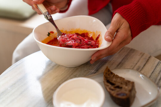 Female eating yummy Borscht Soup