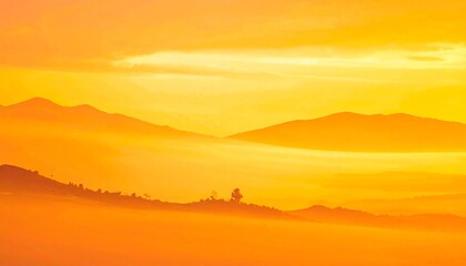 Obraz premium Golden Sunrise Over Misty Mountain Range Landscape.