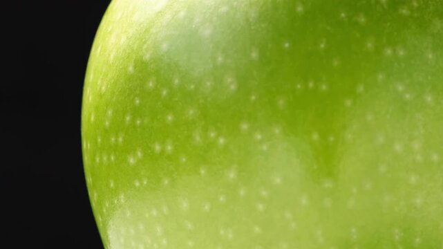 Close up of a delicious fresh and crisp green apple with black background.