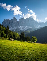 A vibrant vista showcasing rolling green hills, a range of towering mountains under a sunny, clouded sky