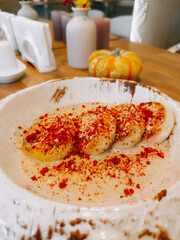 Delicious dessert with banana and spices served in a rustic bowl at a cozy cafe