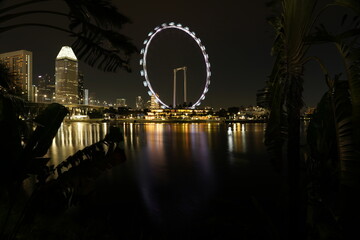 nighttime singapore flyer cityscape illuminated towers urban rhythm