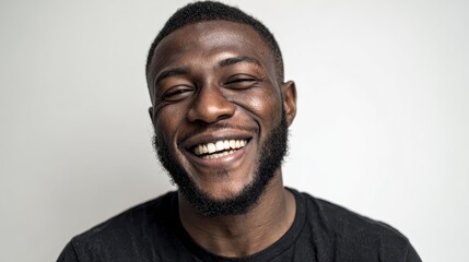 Obraz premium Joyful and self assured black man in studio for university scholarship Smiling African male student with pride and educational chance against a white backdrop