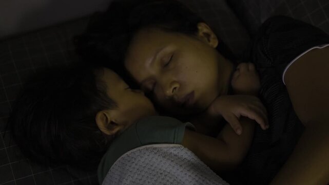 Mom And Child Nap Together, A peaceful ad film of mom and child napping together, soft sunlight wrapping their cozy embrace, perfect for a family commercial or tender lullaby documentary.