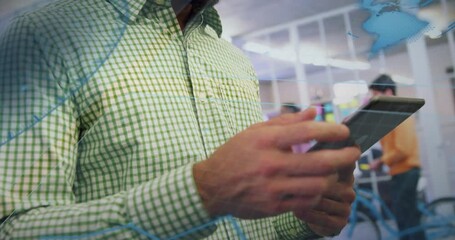 Man tapping tablet and swiping screen, revealing grid interface and blue charts in tech office - Powered by Adobe
