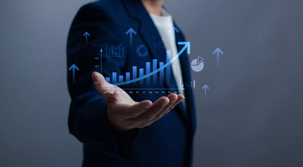 Businessman holding a growing bar chart with upward arrows, symbolizing financial growth, business...