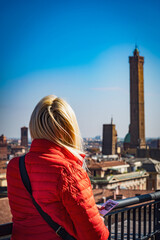 Girl looking to treets, roofs and towers in the old city Bologna, Tuscany, Italy