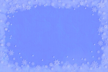Winter evening pale blue surface in frame of white snowflakes